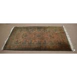 Good quality modern carpet with brown and green field with geometric design, 117cm wide x 215cm