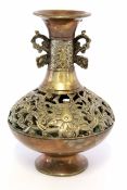 Oriental metal ware vase, the reticulated body decorated with a scroll design with ear-shaped