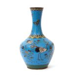 Japanese cloisonne baluster vase decorated with flying cranes and floral decoration on a blue