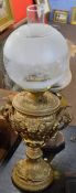 Victorian and later gilt metal mounted oil lamp with globular opaque shade, 65cm high