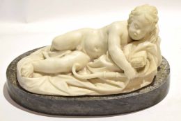 Carved marble figure of a reclined Cupid resting, minor losses, on grey marble base, 37cm x 19cm