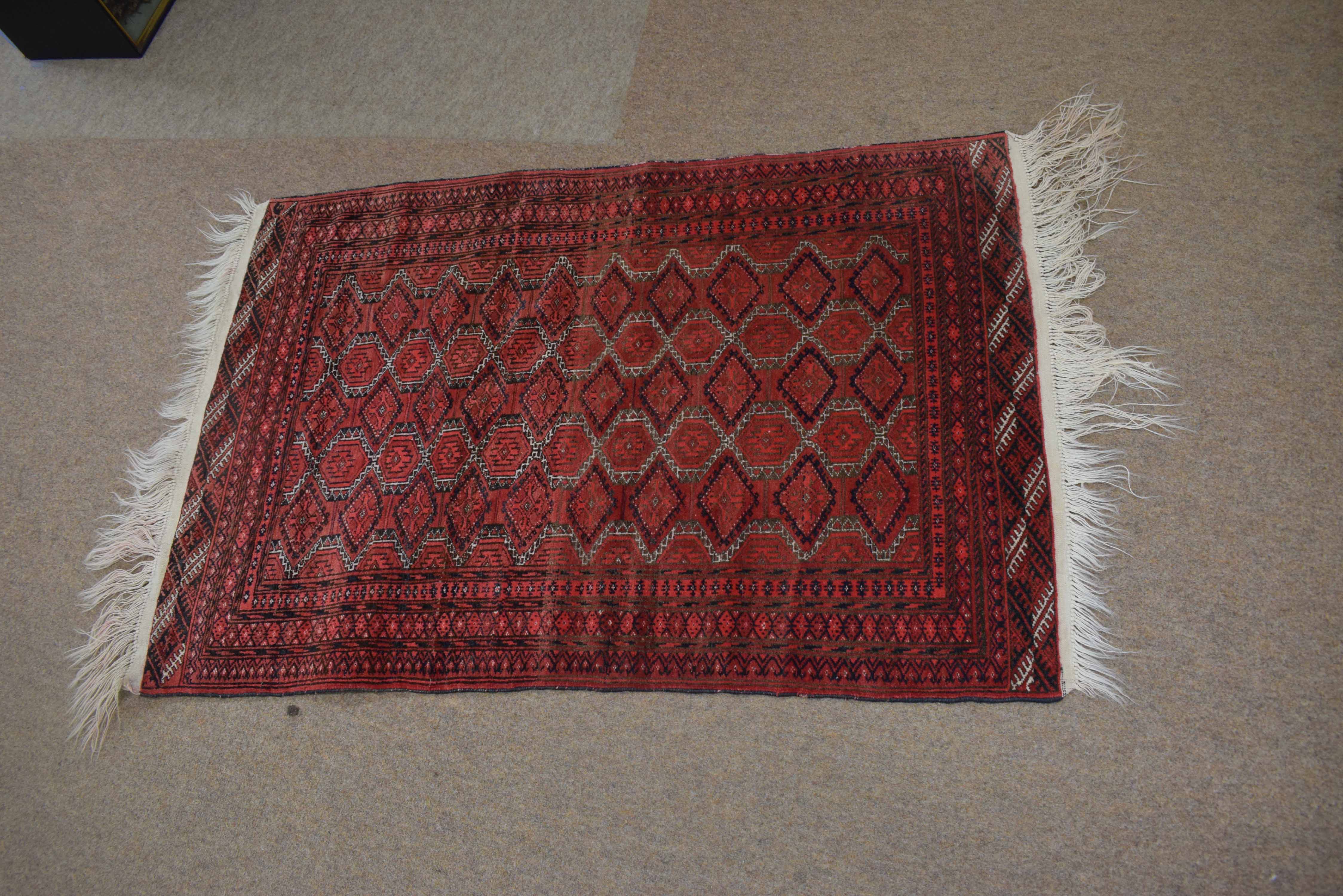 Good quality small Bokhara type carpet with a red field, with diamond repeating lozenge on a multi-