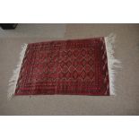 Good quality small Bokhara type carpet with a red field, with diamond repeating lozenge on a multi-