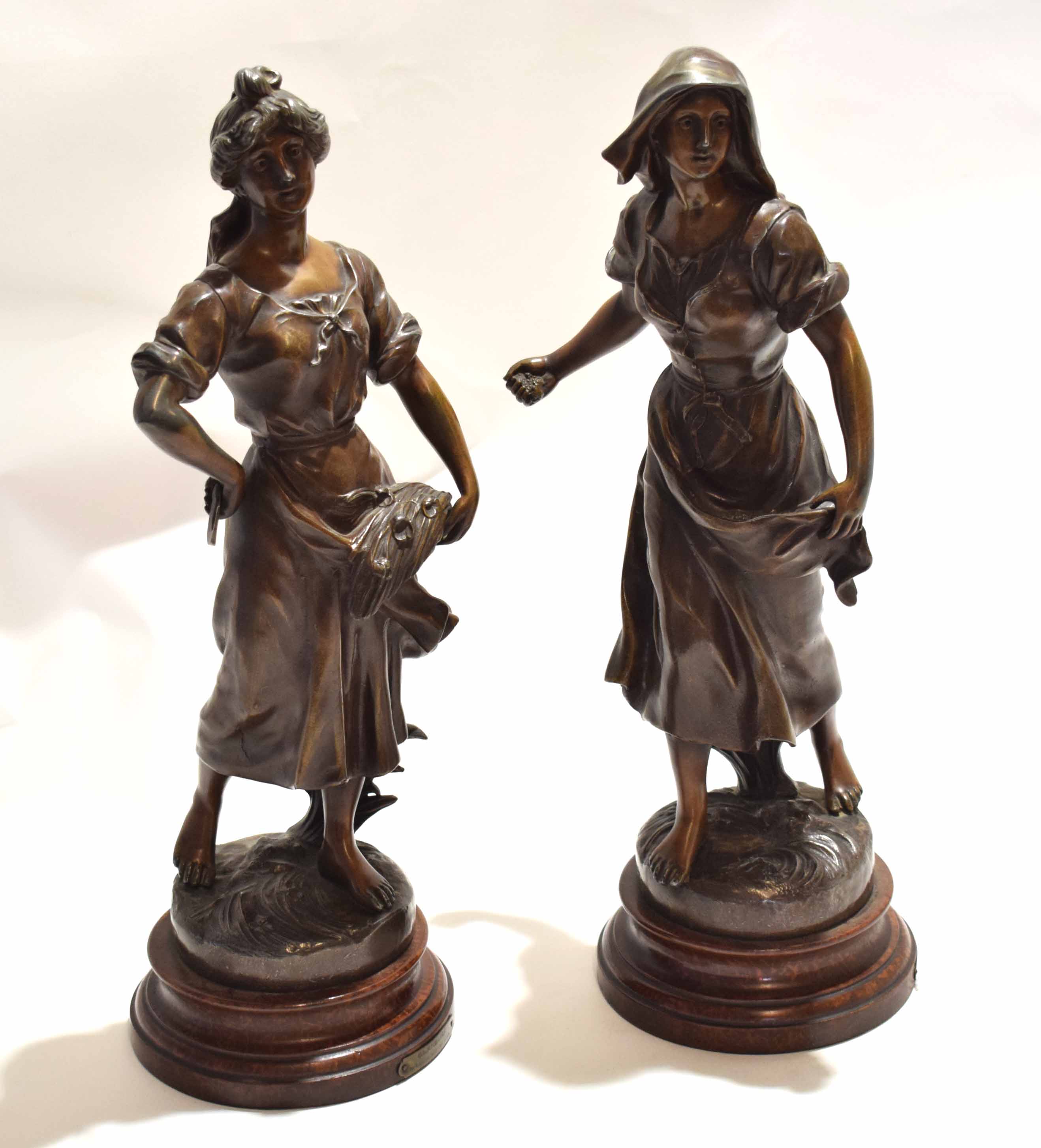 Pair of late 19th century French bronzed spelter figures, one entitled "Glaneuse", the other