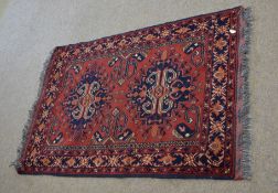 Good quality modern floor rug with rust field and two central geometric lozenges among a floral