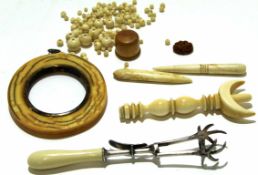 Group of ivory wares including a photo frame and collection of ivory beads and a pair of sugar tongs