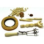 Group of ivory wares including a photo frame and collection of ivory beads and a pair of sugar tongs