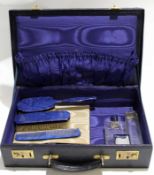 Early 20th century blue leather overnight case containing a few fittings, gilt metal lever locks,