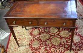 Edwardian inlaid mahogany writing table of rectangular form, having tooled brown leather inset