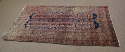 Bokhara type carpet with multi-gulled border with repeating rectangular lozenge centre with inter-