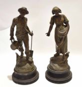 Pair of spelter figures of a farmer and his wife, bearing a spade and a watering can, the lady