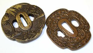 Two Japanese iron Tsubas, one decorated with flowers, the other with a scrolling design, both