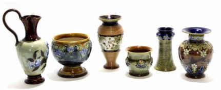 Group of Doulton wares comprising three vases, two bowls and a stoneware ewer with floral design