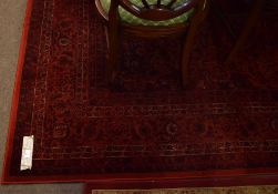 Good quality modern red ground floor rug with floral design and multi-gulled border, 175cm wide x