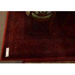 Good quality modern red ground floor rug with floral design and multi-gulled border, 175cm wide x