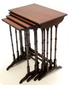 Edwardian mahogany set of four nesting tables with turned bamboo style supports on a splayed foot