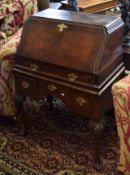 Early/mid-20th century walnut veneered small bureau in Queen Anne style, the cartouche shaped top