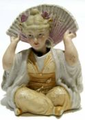 Late 19th century Continental porcelain nodding figure of a lady with fan, 11cm high