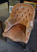 Mid-Victorian mahogany framed button back elbow chair with calix formed short front legs and brass