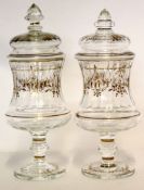 Pair of large glass jars and cover, both with gilt floral decoration, 32cm high