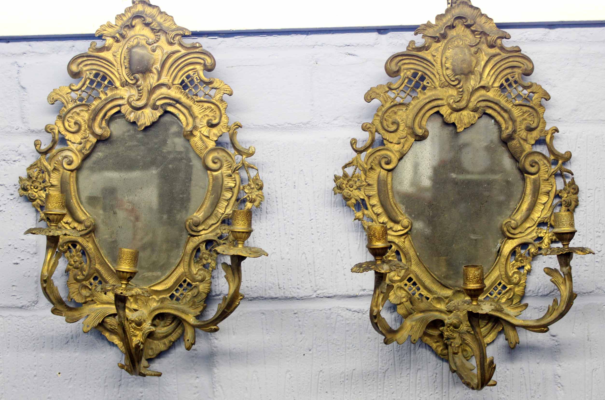 Pair of late 20th century reproduction cast gilt metal triple wall sconces with mirrored backs, in