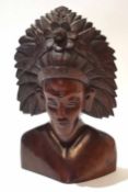 Mid-20th century Far Eastern carved hardwood bust of a chieftain with feather and floral head-dress,