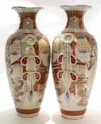 Two large Satsuma earthenware vases decorated in typical fashion with Japanese warriors and