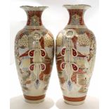 Two large Satsuma earthenware vases decorated in typical fashion with Japanese warriors and