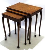 Early 20th century walnut set of three nesting tables with carved shell knuckles, raised on pad