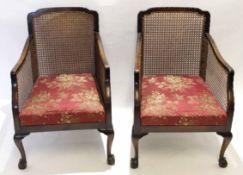 Pair of early 20th century mahogany framed Bergere armchairs with floral damask material seats,