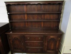 MID-20TH CENTURY OAK FRAMED DRESSER, THE TOP FITTED WITH TWO FIXED SHELVES AND PANELLED BACK, THE