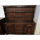 MID-20TH CENTURY OAK FRAMED DRESSER, THE TOP FITTED WITH TWO FIXED SHELVES AND PANELLED BACK, THE