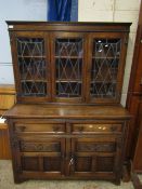 EARLY 20TH CENTURY OAK FRAMED DRESSER WITH TWO LEADED AND GLAZED DOORS TO TOP, TWO DRAWERS OVER