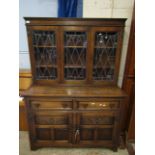 EARLY 20TH CENTURY OAK FRAMED DRESSER WITH TWO LEADED AND GLAZED DOORS TO TOP, TWO DRAWERS OVER