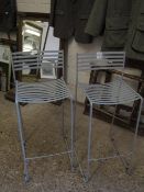 TWO STRAPWORK METAL BAR STOOLS