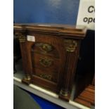 OAK FRAMED SMOKERS CABINET WITH SINGLE GLAZED DOOR WITH COLUMN DETAIL FITTED WITH THREE DRAWERS