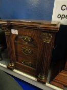 OAK FRAMED SMOKERS CABINET WITH SINGLE GLAZED DOOR WITH COLUMN DETAIL FITTED WITH THREE DRAWERS