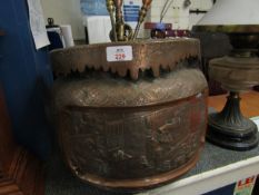 PRESSED COPPER JARDINIERE WITH ORIENTAL SCENES (LACKING FEET) TOGETHER WITH BRASS ANDIRONS