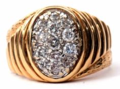 Gents oval diamond cluster ring with textured and chased descending box shoulders, stamped 14K, size