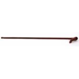 Bamboo walking cane with plain tapering shaft with steel ferrule and integral carved handle of a