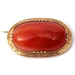 Antique agate brooch, large cabochon framed agate in a yellow metal engraved mount, 45 x 25mm