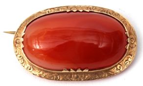 Antique agate brooch, large cabochon framed agate in a yellow metal engraved mount, 45 x 25mm