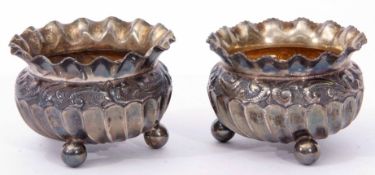 Two Edward VII open salts, each of compressed circular form with flared and shaped rims and embossed