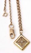 A 585 stamped square shaped pendant of pierced scroll design with a central cabochon stone, 1.