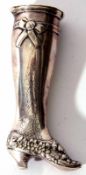 Continental white metal pill canister modelled in the form of a lady's right leg with floral