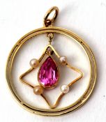 A 15c stamped open work pendant of circular form with an articulated pear shaped pink stone and