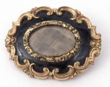 Victorian mourning brooch, the oval glazed centre with plaited hair panel, within a black enamel