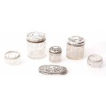 Mixed Lot: comprising three various cylindrical silver lidded and clear cut glass toiletry jars,
