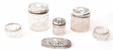 Mixed Lot: comprising three various cylindrical silver lidded and clear cut glass toiletry jars,