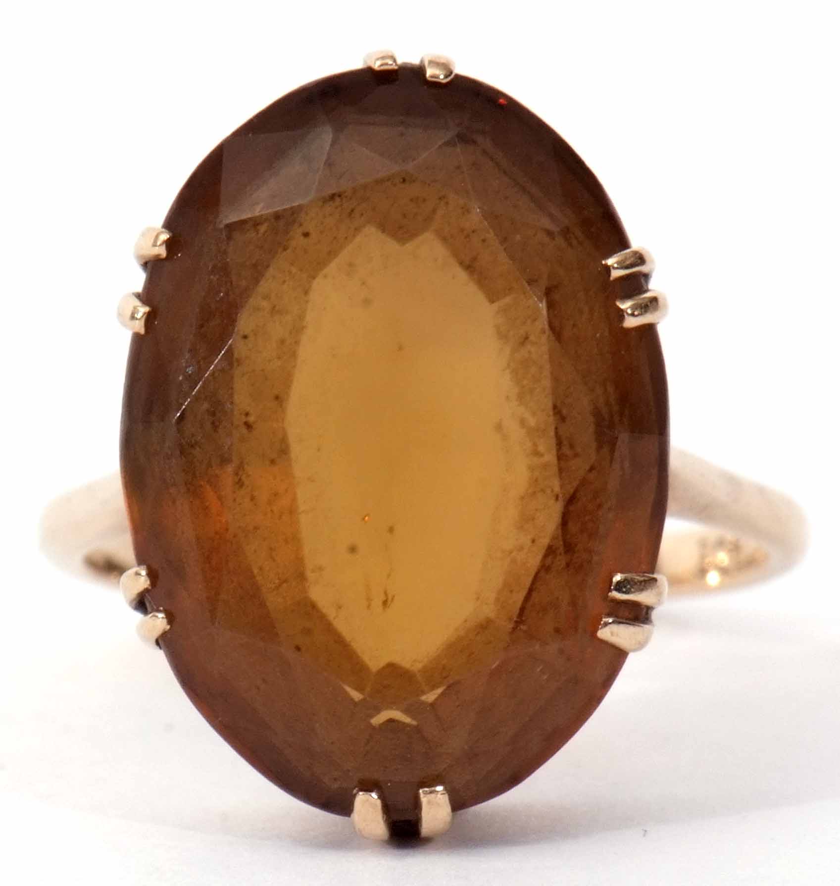 A 9ct stamped citrine dress ring, oval shaped (20 x 14mm), faceted design, claw set and raised in